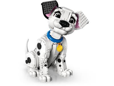 A toy dog built from interlocking blocks, resembling a Dalmatian, with a white body, black spots, floppy ears, a blue collar, and a gold medallion, shown on a plain white background.