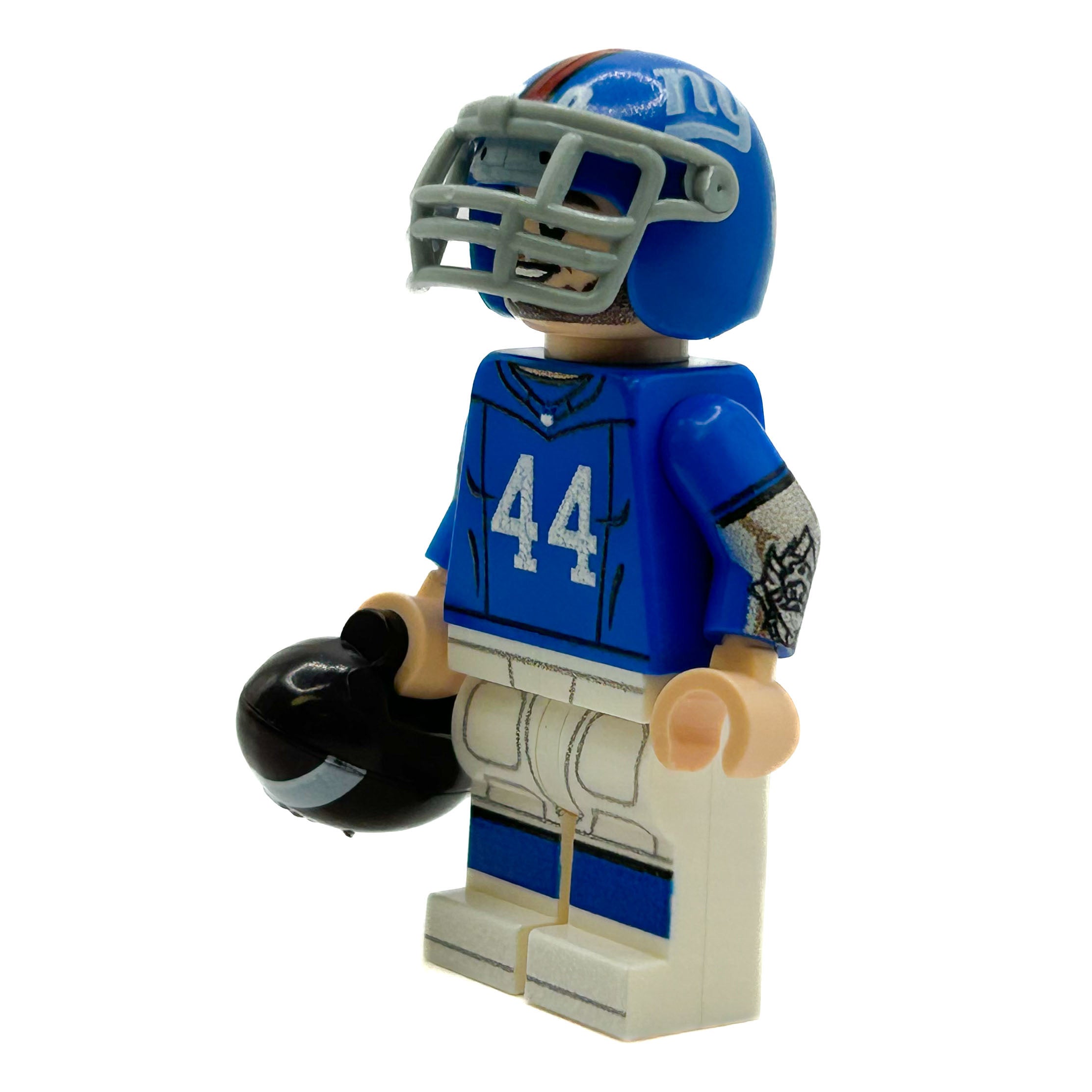 Toy figure of a football player in a blue uniform with number 44 on a white background
