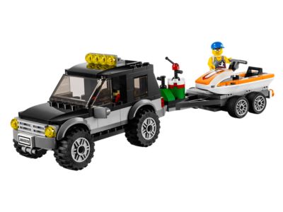 Toy model of a truck with a trailer carrying a boat on a white background