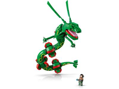 Green and red building block toy dragon with a small minifigure standing beside it on a white background.