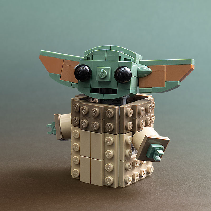 LEGO model of a character with a green head and brown ears on a gray background