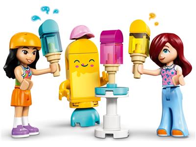 LEGO Duplo Friends toy set featuring two female minifigures holding colorful popsicle-shaped tools, with a yellow smiling robot in the center on a white background.