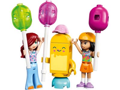 A LEGO Friends toy set featuring three minifigures and colorful maces on a plain white background. The set includes a girl with red hair in blue pants, a girl with dark hair in an orange skirt, and a yellow robot-like figure with a pink hat.