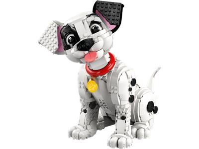 A toy dog built from interlocking building blocks, shown against a plain white background. The dog is primarily white with black spots, a red collar, and a yellow tag.