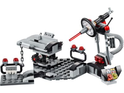 A gray and black toy construction vehicle or workshop set with red accents, shown on a plain white background.