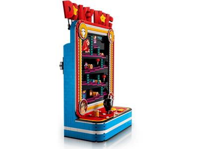 A toy building-block style arcade machine or game cabinet shown on a clean white background. The product is predominantly bright blue with red, yellow, orange, and black details, including a red sign at the top and a play button on the front.