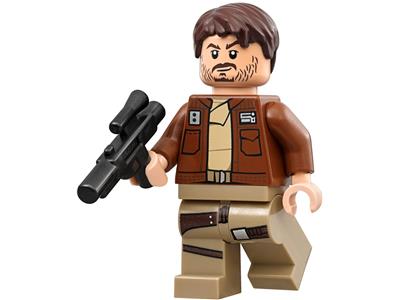 A LEGO minifigure with brown hair and beard, wearing a brown jacket over a tan shirt and tan pants, holding a black blaster against a plain white background.