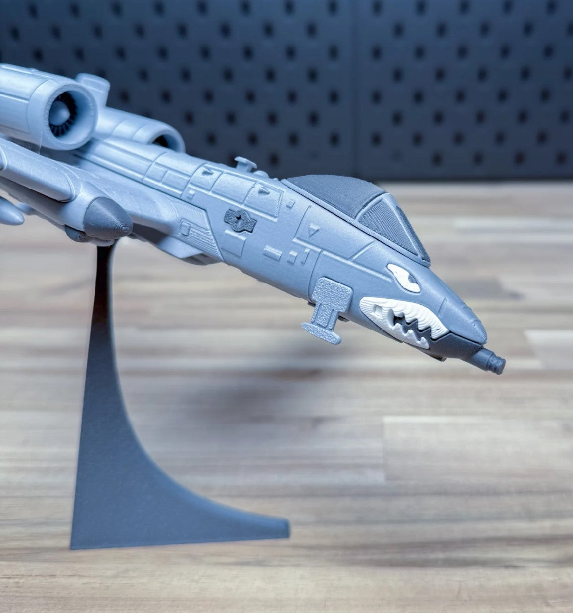 Blue spaceship model on a stand with a blurred background